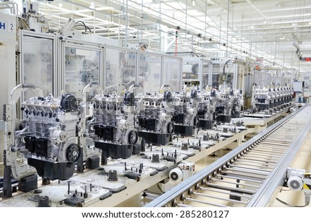 Production assembly line for manufacturing of the engines in the car factory. Car factory. Car parts. Engine factory. New engine factory. Engines on line. Royalty-Free Stock Photo #285280127