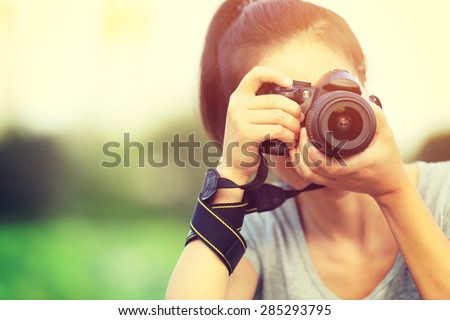 young woman photographer taking photo outdoor