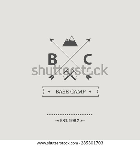 Vintage mountain climbing badge. Minimalist retro graphic design with arrows, pickaxes and mountains. Eps10 vector illustration.