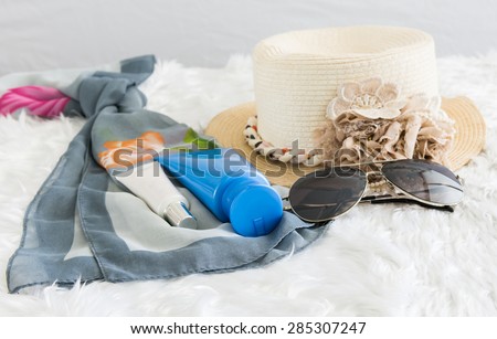 stylish hat woman sunglasses and tablet fashion scarf, sunscreen on woollens background. vacation and travel concept