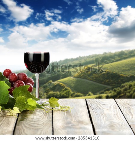 Landscape of Tuscany and fresh fruits glass of wine and free space for your bottle 