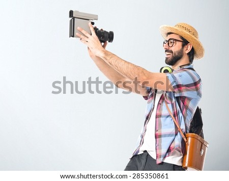 Tourist filming over textured background