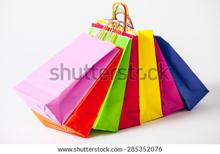 Multicolored paper bags, white background