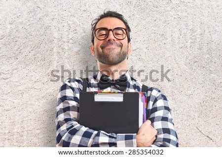 Posh boy holding books over textured background