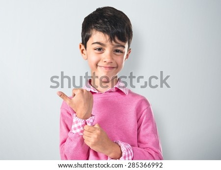Portratit of young boy with pink sweater over textured background