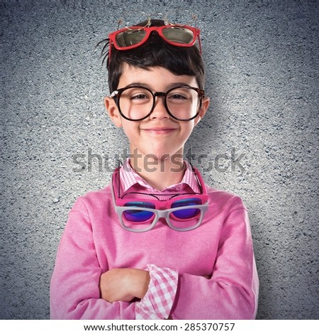 Happy boy with many glasses over textured background