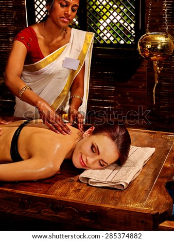 Young woman having oil spa Indian treatment.