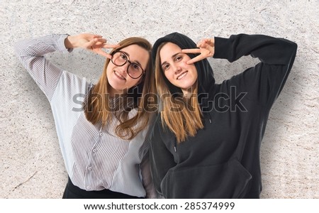 Happy twin sisters over textured background