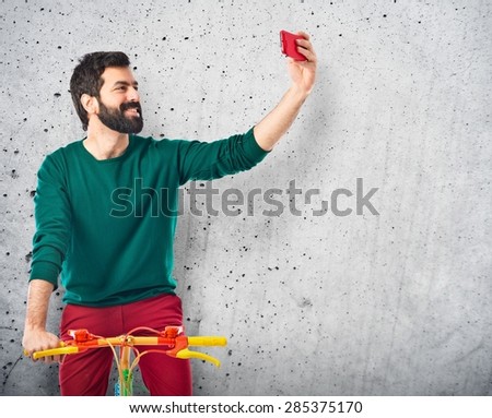 Hipster man with his bike over textured background