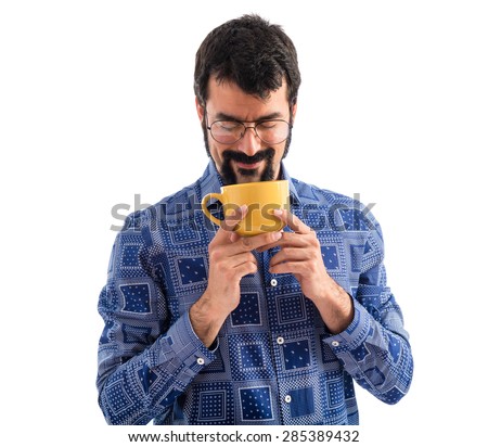 Vintage young man holding a cup of coffee 