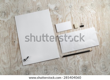 Blank stationery and corporate identity template on light wooden background.  Mock-up for graphic designers portfolios. Top view. 