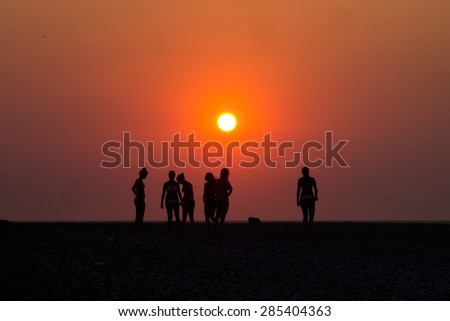 Silhouettes of Girls playing on the beach on sunset