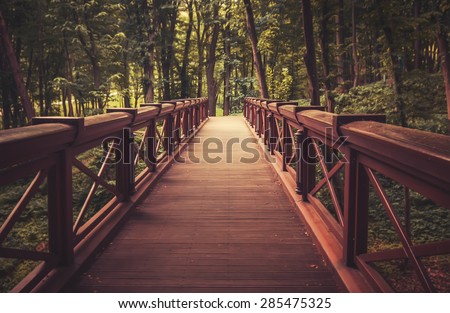 old wooden bridge in  deep forest, natural vintage background Royalty-Free Stock Photo #285475325