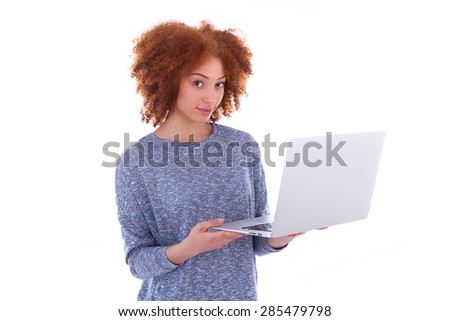 Black African American student girl holding a laptop and pointing to the screen, over white background