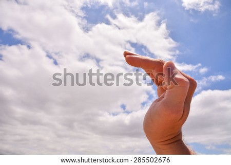 Picture of an Hand over a Cloudy Sky