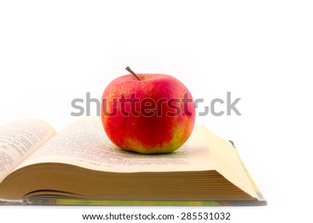 Lovely fresh ripe apple and book pages