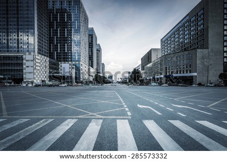 empty road and modern office buildings Royalty-Free Stock Photo #285573332