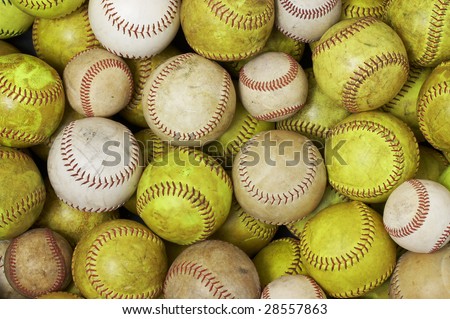 a picture of old softballs and baseballs
