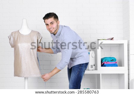 Young man fashion designer in studio