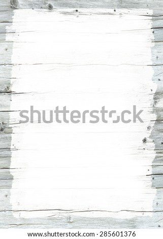 White painted area on weathered grey wooden wall