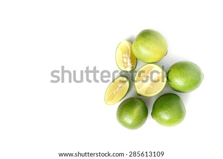 Green lemons on white background