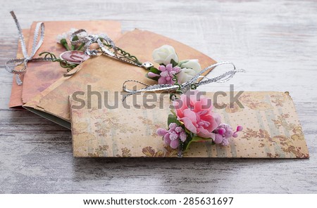  wedding invitations made of paper on wooden vintage background