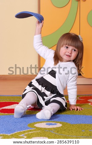Child in the nursery on the carpet 
