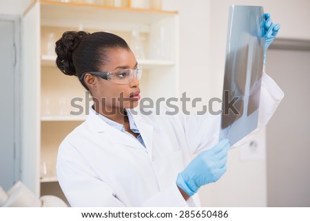 Concentrated scientist looking at x-ray in laboratory