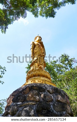 standing Buddha Statue. sky background