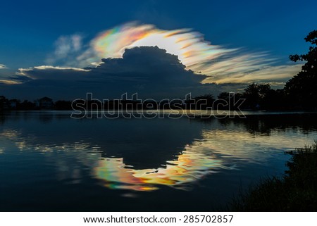 Colorful iridescent sky with black cloud in the evening time