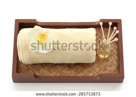 Towel and reed diffuser in a tray