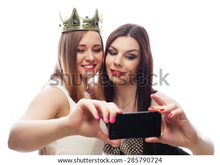 two young funny women taking selfie with mobile phone 