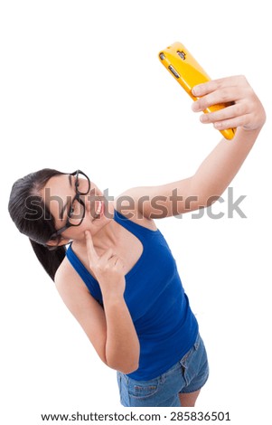 young woman taking selfie picture in the studio