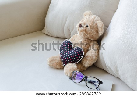 Dolly bears Lonely and  notebook on sofa in  living room