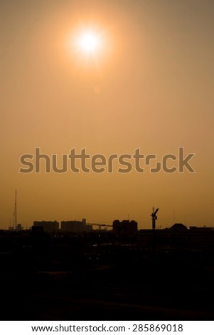 Vintage filter :Silhouette of landscape sunset scene with city building.