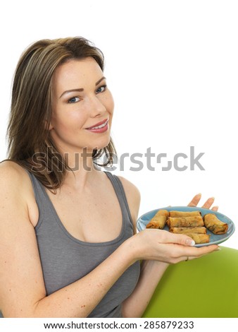 Attractive Happy Smiling Young Woman Holding A Plate of Chinese Style Spring Rolls