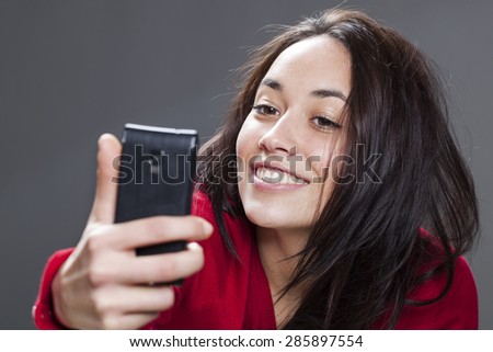 20s girl taking her selfie with seductive pose and smile
