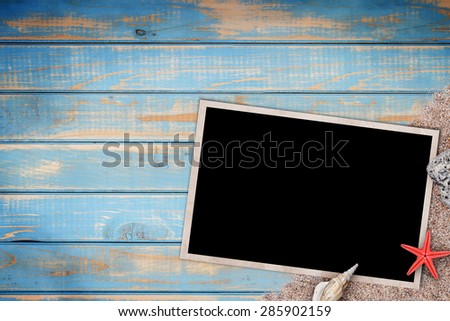 Summer like old style empty photo card lying on blue wooden board