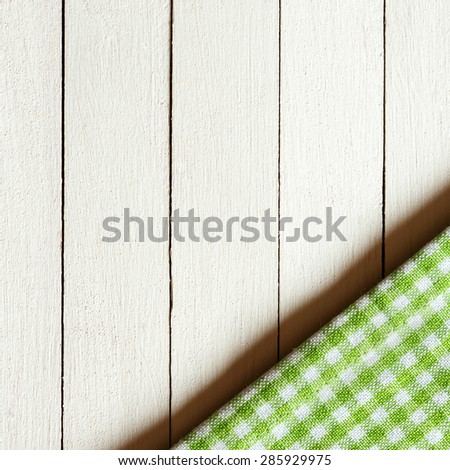 Tablecloth textile texture on wooden table background/ Checkered tablecloth wooden desk background