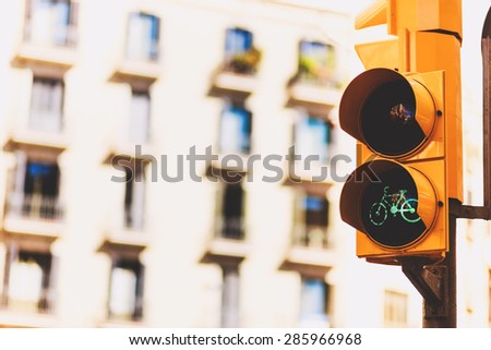 Urban yellow traffic lights and a pedestrian crossing on the blurred street background