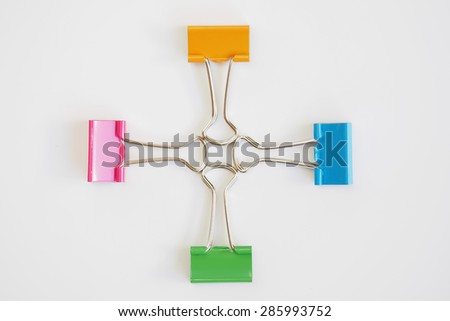 Colorful binder clips on white background