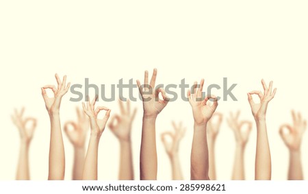 gesture and body parts concept - human hands showing ok sign