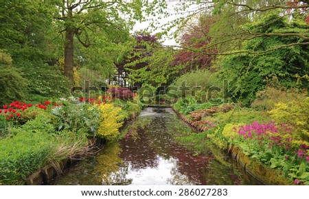 Tulips beside a Moat in the Garden of Dunham Maseey, Cheshire, England, UK Royalty-Free Stock Photo #286027283