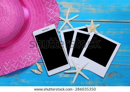 summer accessories and blank mobile  on wooden planks