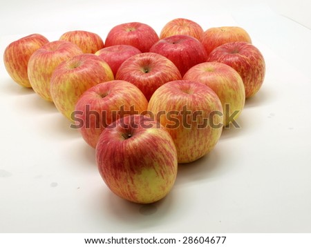 Lots of red and yellow apples on white background.