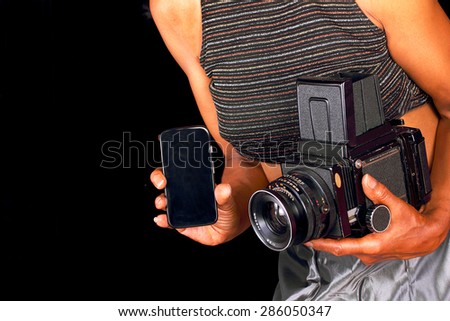 African American woman using both new and old cameras