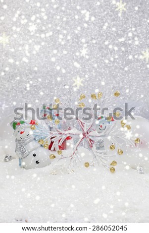 Christmas decoration. Cheerful snowman and Christmas tree decorations. Winter background. High key with shallow depth of field