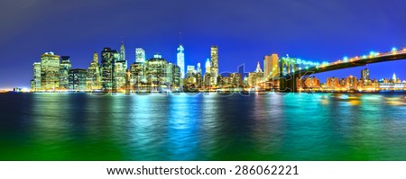 Panorama of Manhattan skyline and Brooklyn Bridge at night