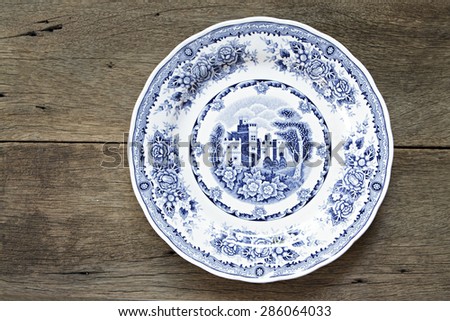 Vintage dish on wooden background Royalty-Free Stock Photo #286064033