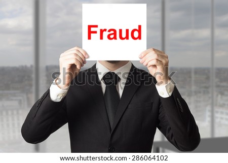 businessman in black suit hiding face fraud